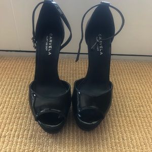 Kurt Greiger peep toe pumps.